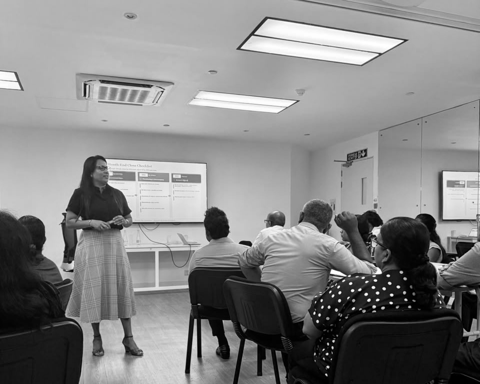Facilitator presenting a month-end close checklist to the group